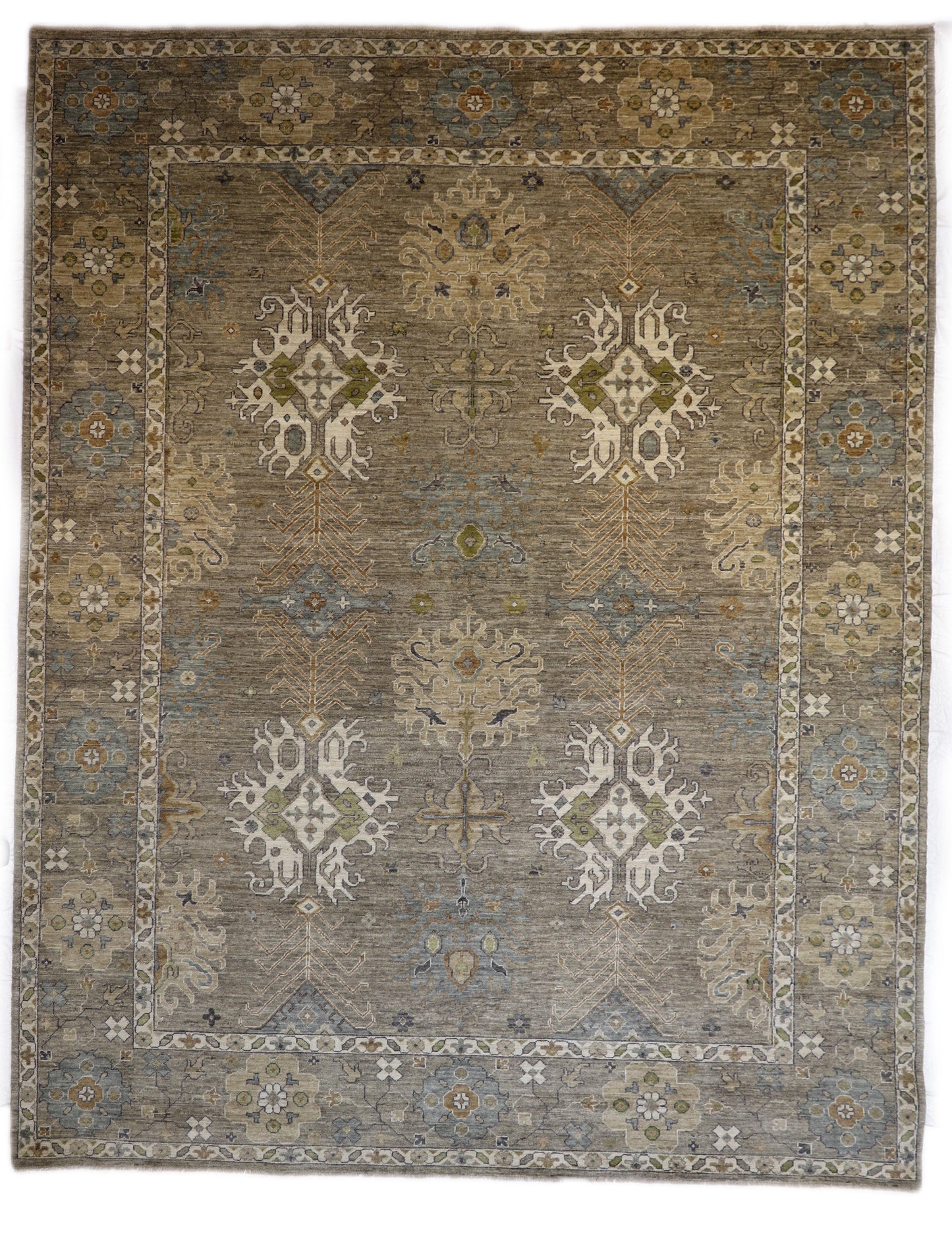A hand-knotted wool rug with a coastal design in shades of grey, blue, ivory, brown, orange, green, and taupe.