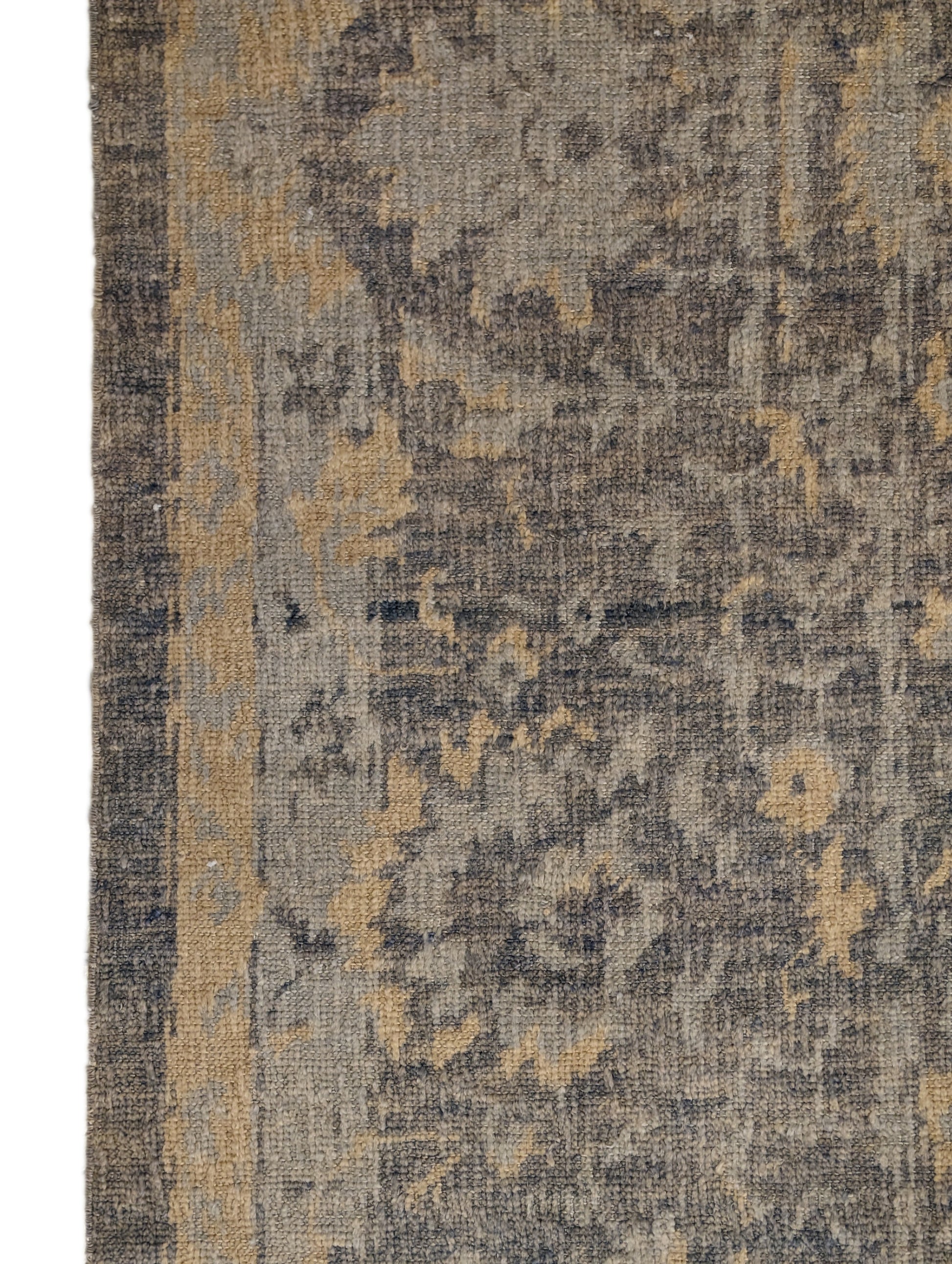 A hand-knotted wool rug with a coastal-inspired design in shades of ivory, beige, grey, blue, smokey green, light yellow, and soft brown.