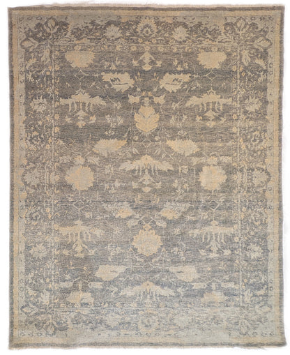 A hand-knotted wool rug with a coastal-inspired design in shades of ivory, beige, grey, blue, smokey green, light yellow, and soft brown.