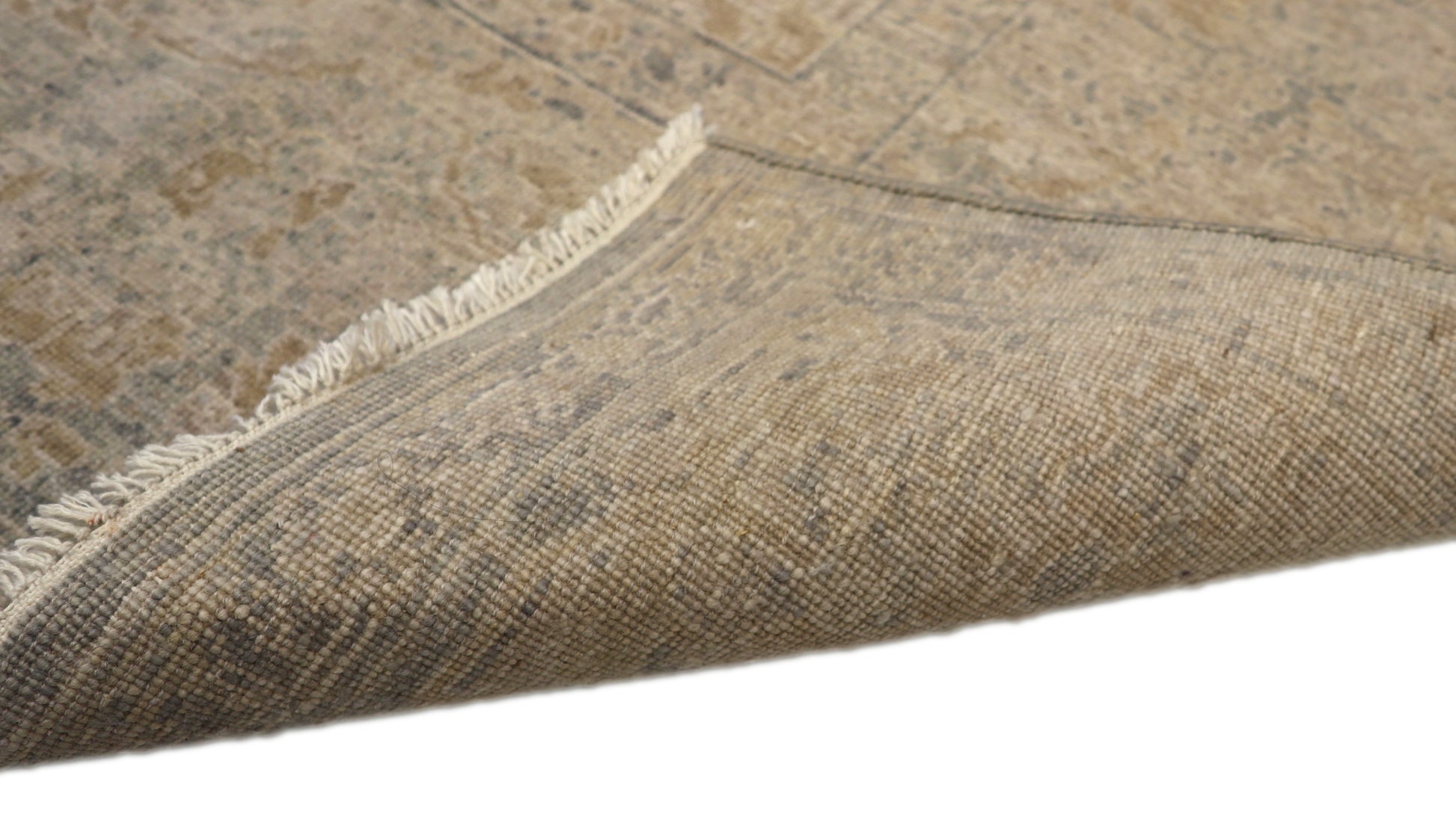 Hand-knotted wool rug with an antique finish in sun-bleached sand, seashell ivory, ocean blue, and driftwood gray.