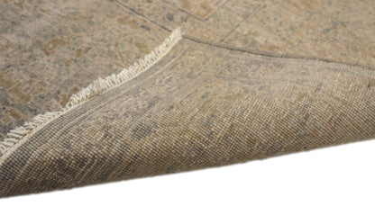 Hand-knotted wool rug with an antique finish in sun-bleached sand, seashell ivory, ocean blue, and driftwood gray.