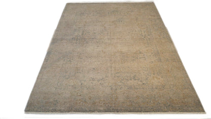 Hand-knotted wool rug with an antique finish in sun-bleached sand, seashell ivory, ocean blue, and driftwood gray.