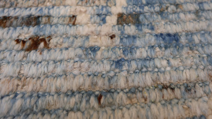 Hand-knotted blue and beige diamond patterned rug with a plush, cozy pile.