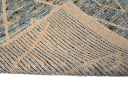 Hand-knotted blue and beige diamond patterned rug with a plush, cozy pile.