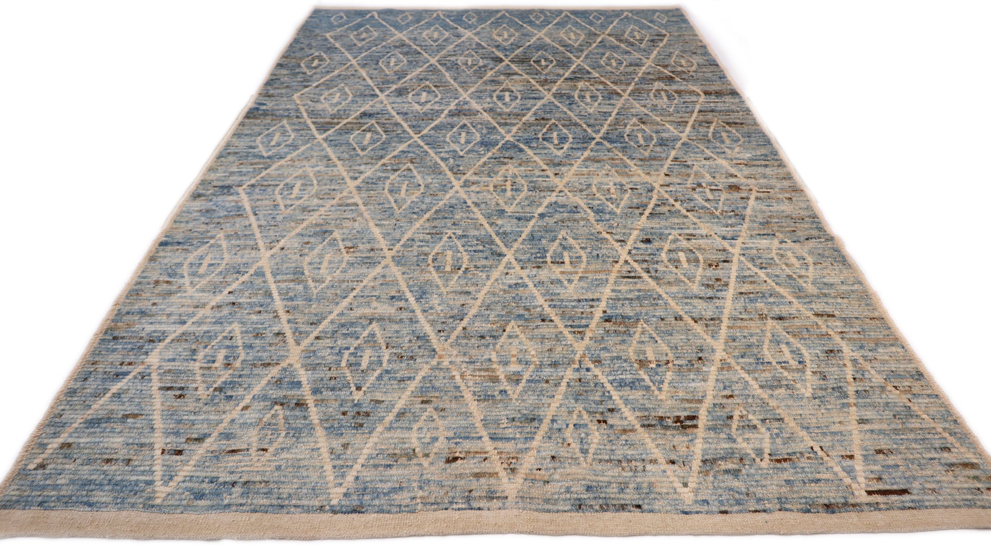 Hand-knotted blue and beige diamond patterned rug with a plush, cozy pile.