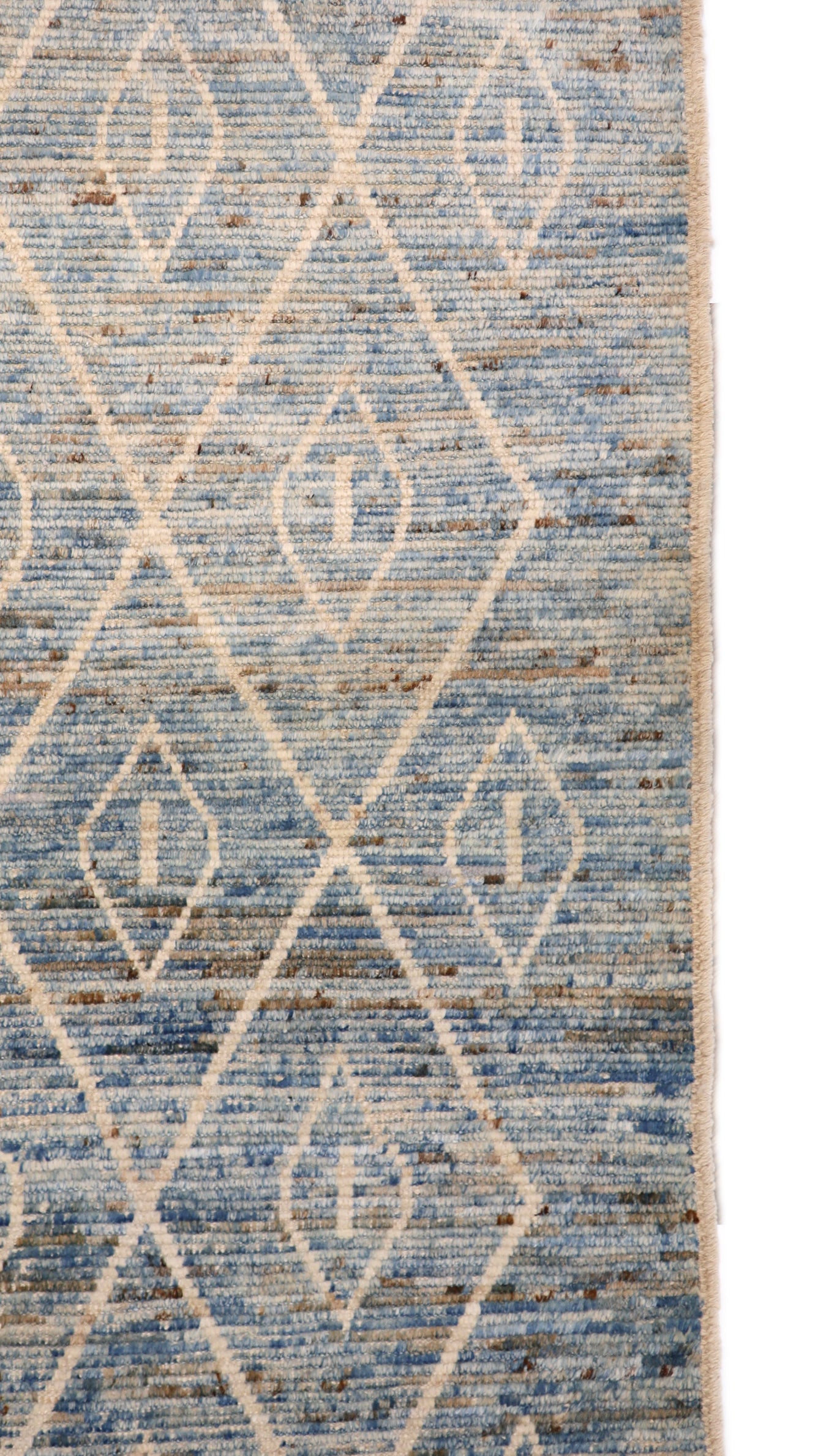Hand-knotted blue and beige diamond patterned rug with a plush, cozy pile.