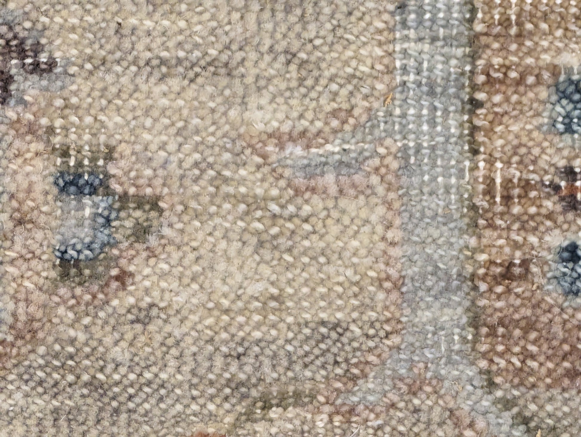 A hand-knotted wool rug with a traditional and coastal design in beige, blue, brown, and gold colors.