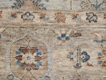 A hand-knotted wool rug with a traditional and coastal design in beige, blue, brown, and gold colors.