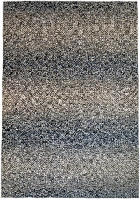 A hand-knotted wool rug with a net pattern in shades of beige, ivory, cream, and blue.