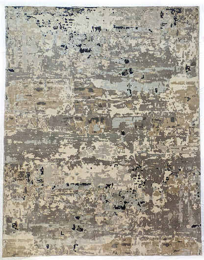 A luxurious coastal-themed rug featuring a blend of beige, gray, blue, and green colors with a textured and rugged texture. Wool and silk. 