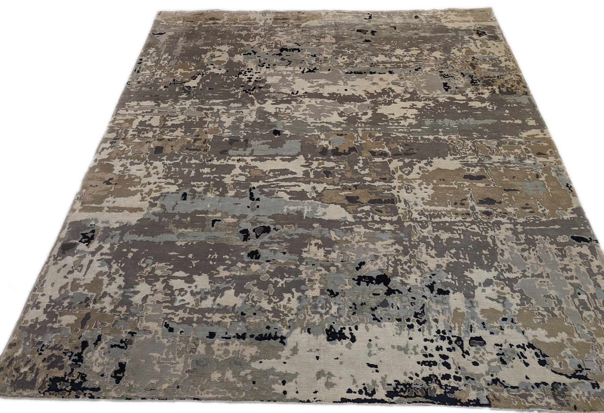 A luxurious coastal-themed rug featuring a blend of beige, gray, blue, and green colors with a textured and rugged texture. Wool and silk. 