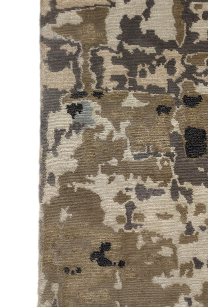 A luxurious coastal-themed rug featuring a blend of beige, gray, blue, and green colors with a textured and rugged texture. Wool and silk. 