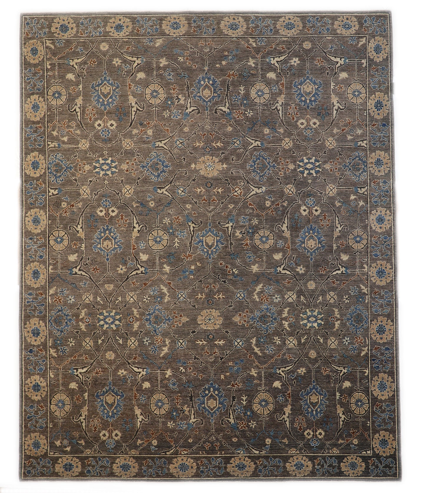 Hand-knotted decorative wool rug with a luxurious pile in misty gray and weathered seabed tones with Atlantic blue and rust accents.
