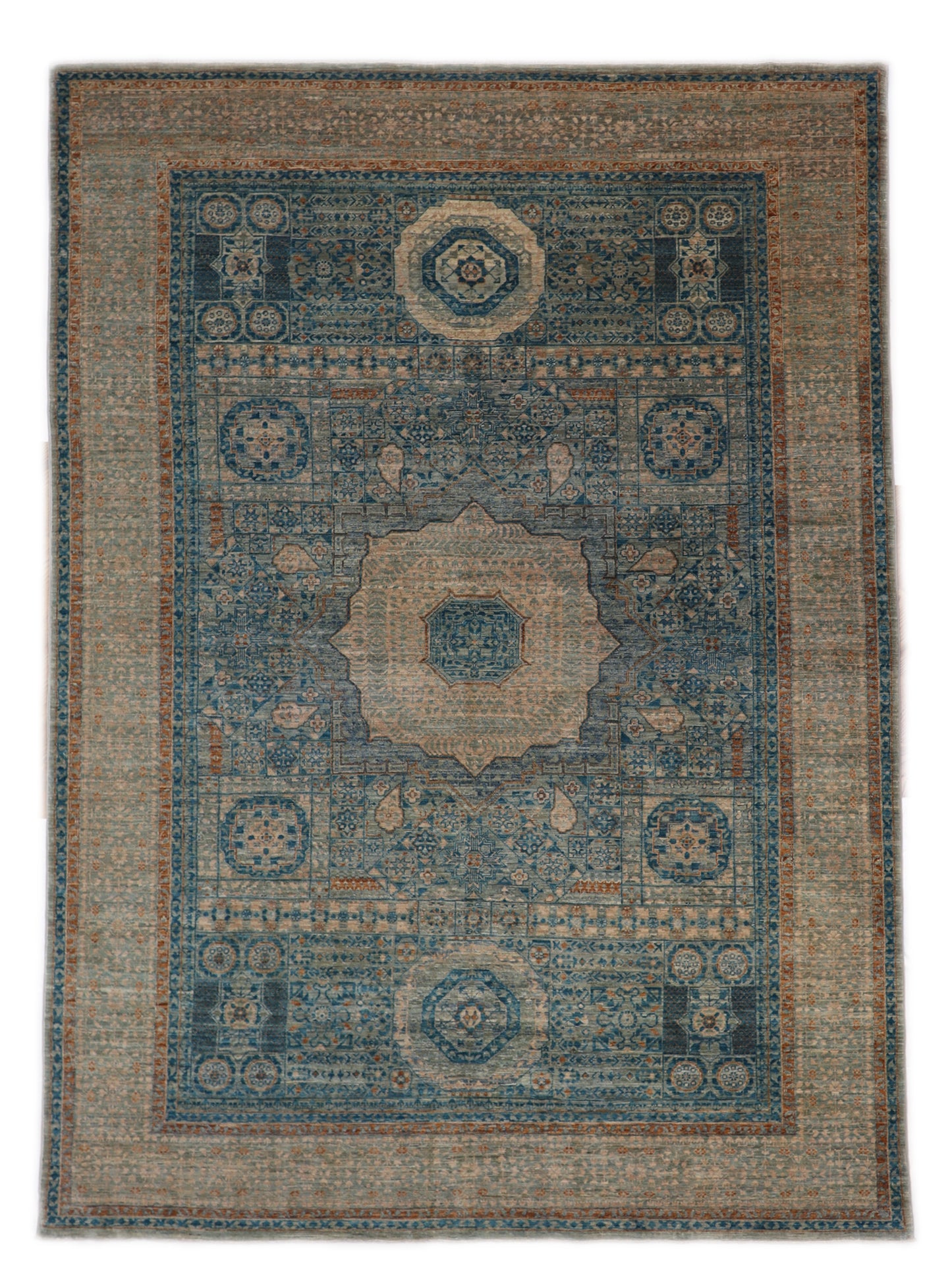 Hand-knotted Intricate patterned rug in lagoon blue and stormy teal with accents of sand, driftwood grey, and coral pink.