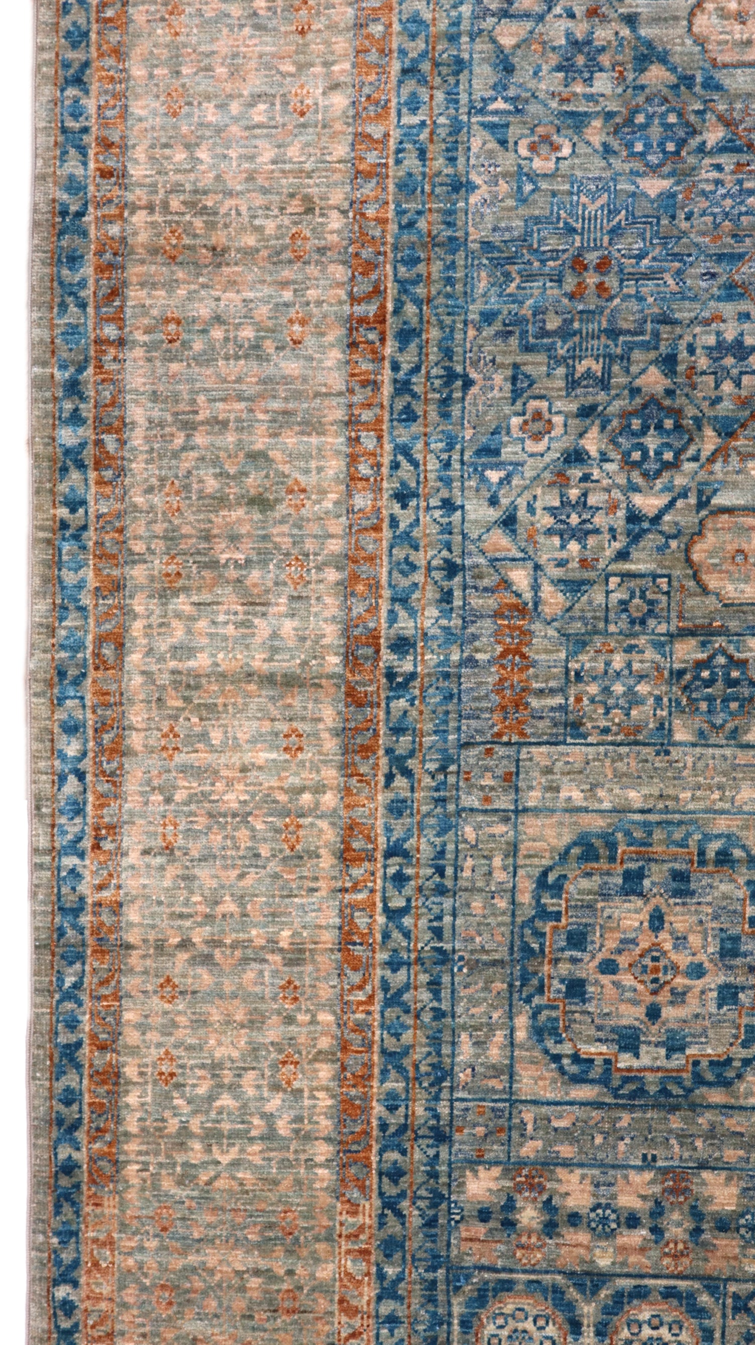 Hand-knotted Intricate patterned rug in lagoon blue and stormy teal with accents of sand, driftwood grey, and coral pink.