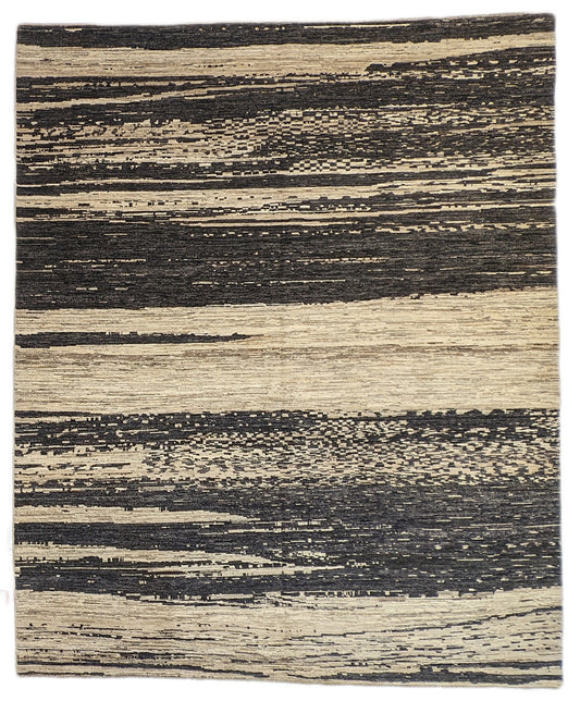 A hand-knotted wool rug with a cozy pile, featuring natural tones of ivory, beige, gray, and brown.
