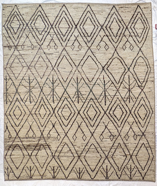 A hand-knotted wool rug with a geometric pattern in natural tones of beige, brown, and gray. Cozy pile.
