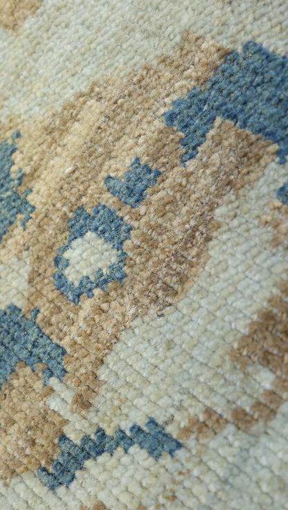 Hand-knotted rug with geometric transitional pattern in beige, blue, and brown. Low pile 