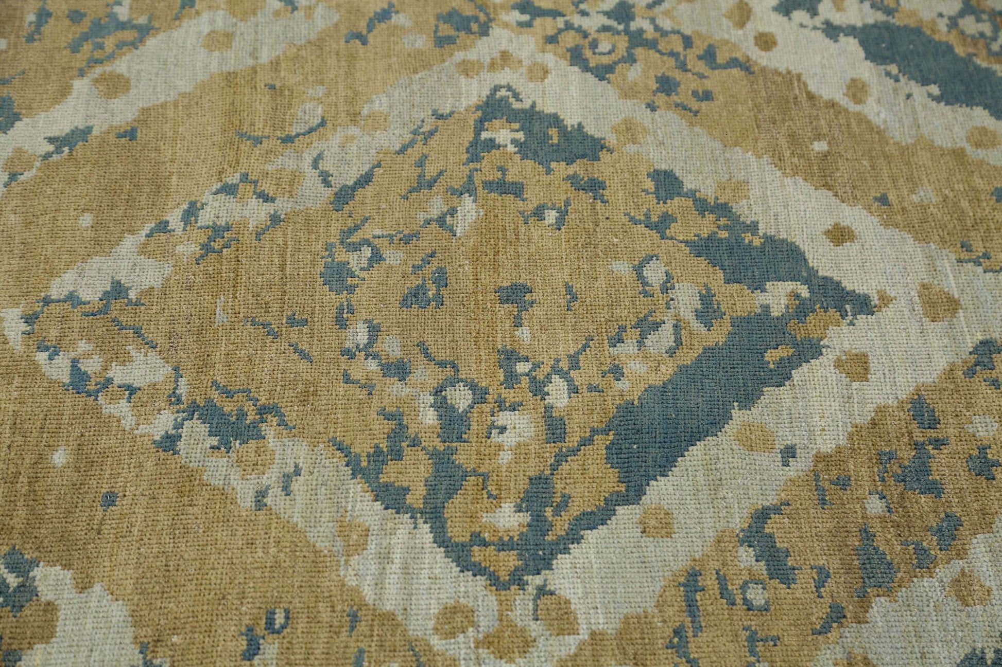 Hand-knotted rug with geometric transitional pattern in beige, blue, and brown. Low pile 