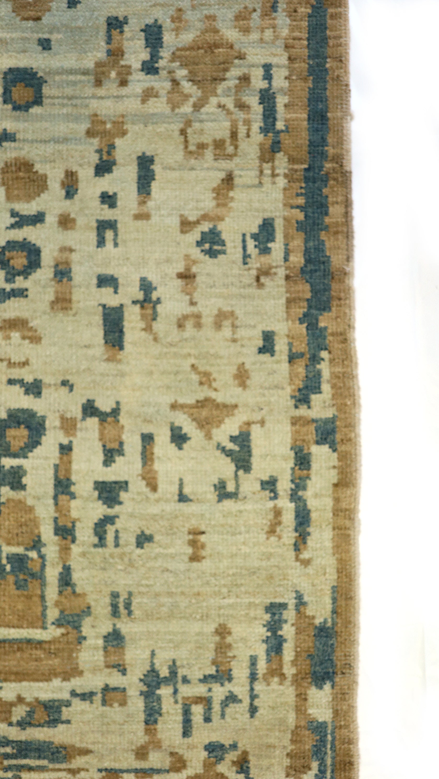 Hand-knotted rug with geometric transitional pattern in beige, blue, and brown. Low pile 
