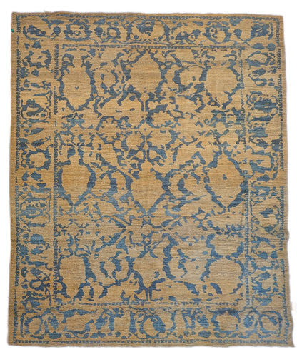A hand-knotted wool rug with a geometric pattern in natural jute brown and muted aquamarine undertones. Low pile. 