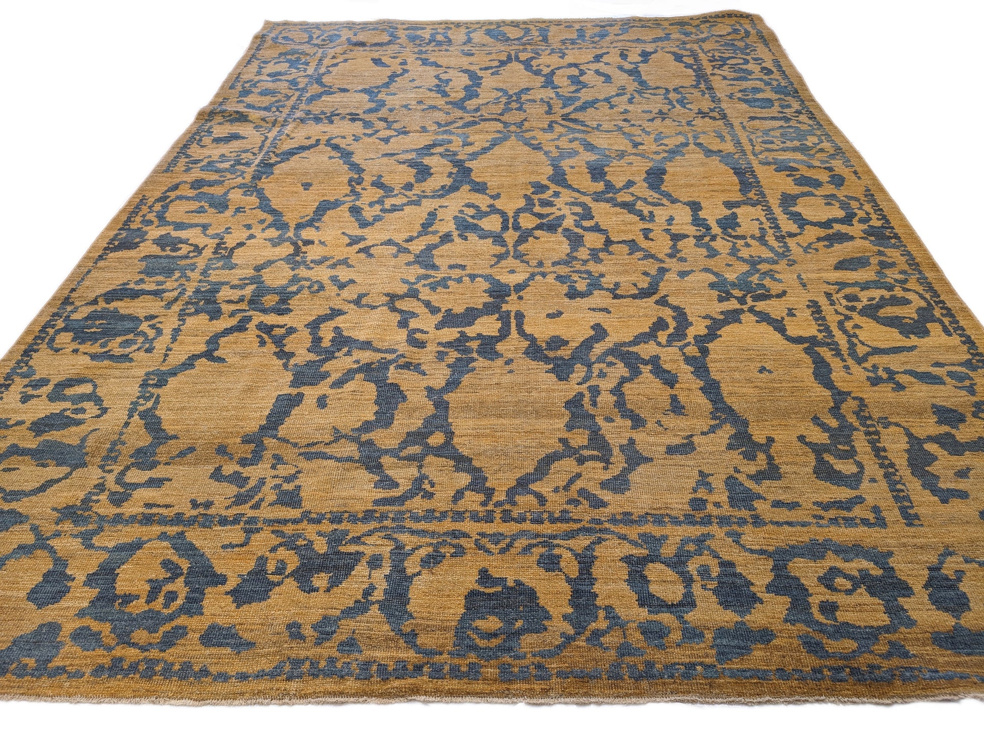A hand-knotted wool rug with a geometric pattern in natural jute brown and muted aquamarine undertones. Low pile. 