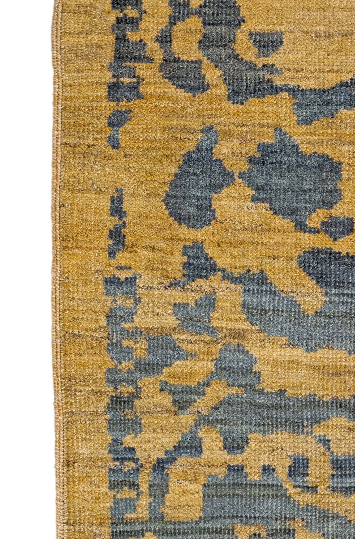 A hand-knotted wool rug with a geometric pattern in natural jute brown and muted aquamarine undertones. Low pile. 