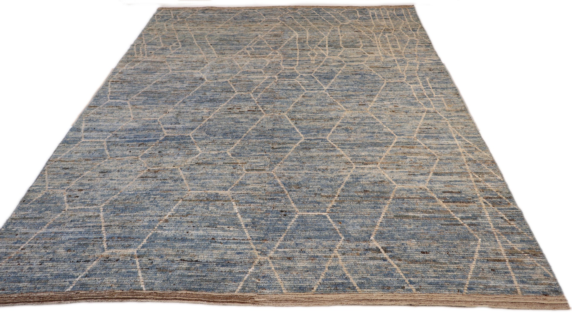 Hand-knotted geometric wool rug with a high pile and large knots in blue, ivory, beige, grey, and brown.