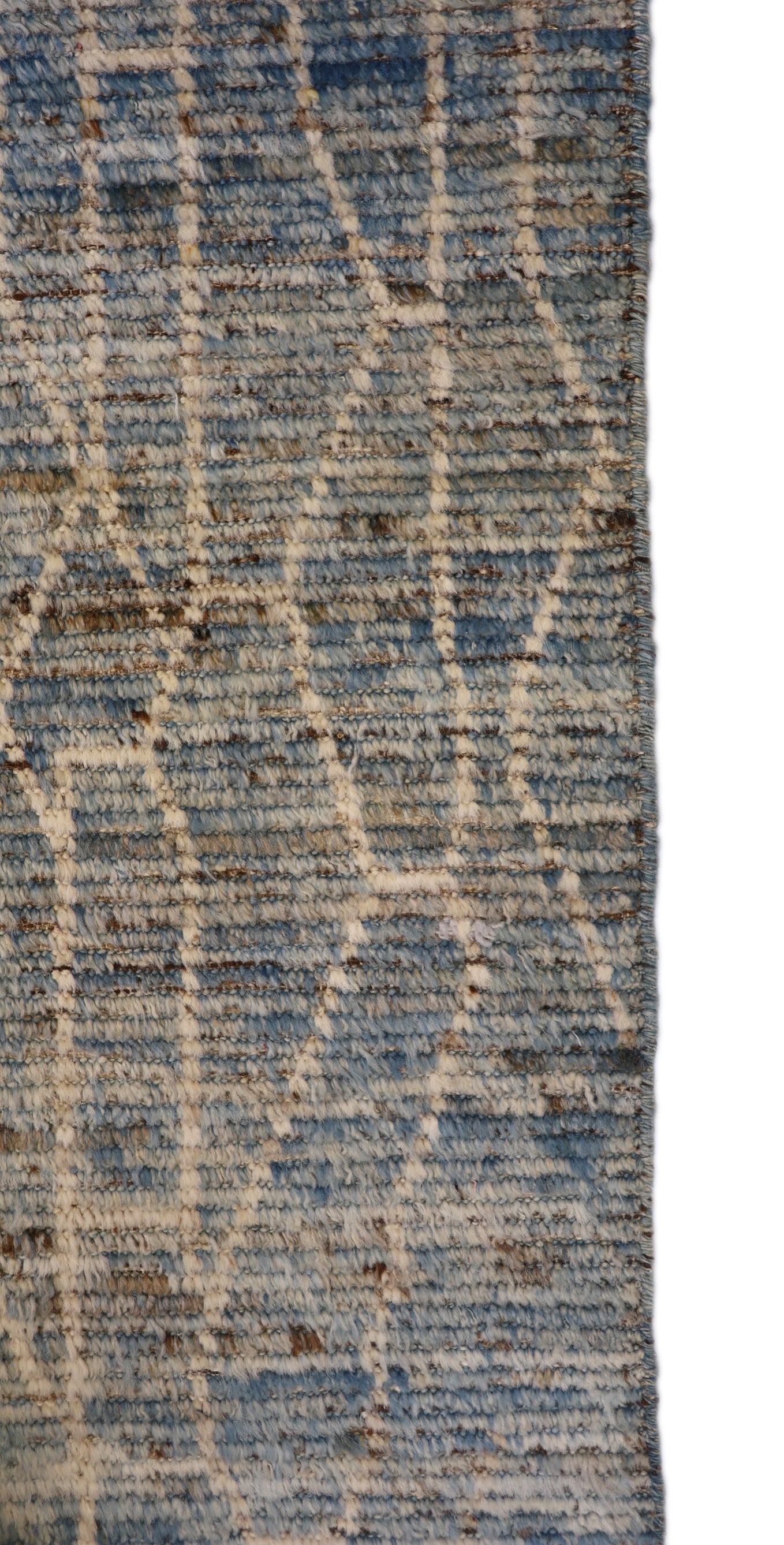 Hand-knotted geometric wool rug with a high pile and large knots in blue, ivory, beige, grey, and brown.