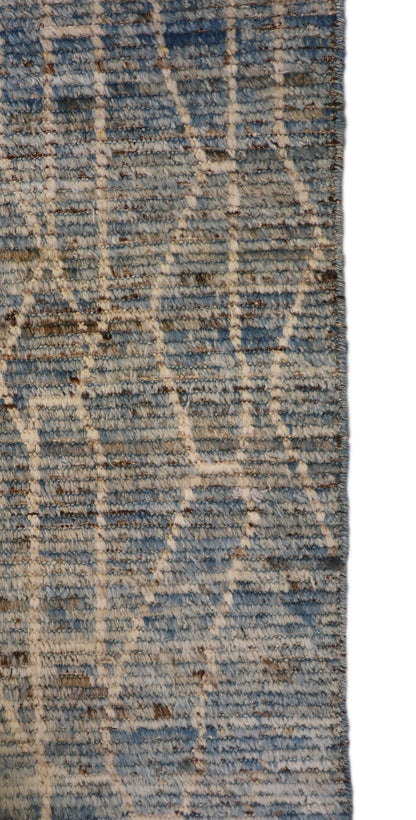 Hand-knotted geometric wool rug with a high pile and large knots in blue, ivory, beige, grey, and brown.