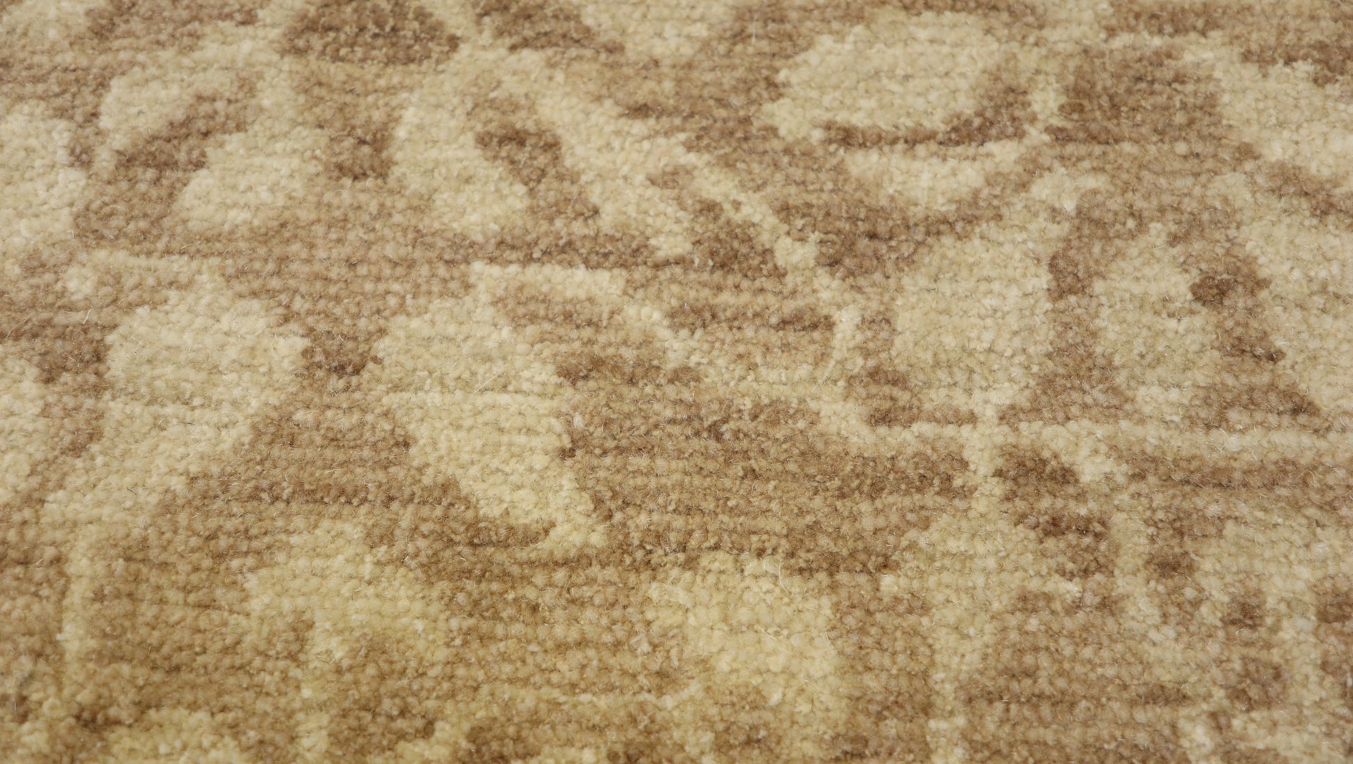 Hand- knotted transitional rug with tones of beige and ivory. 