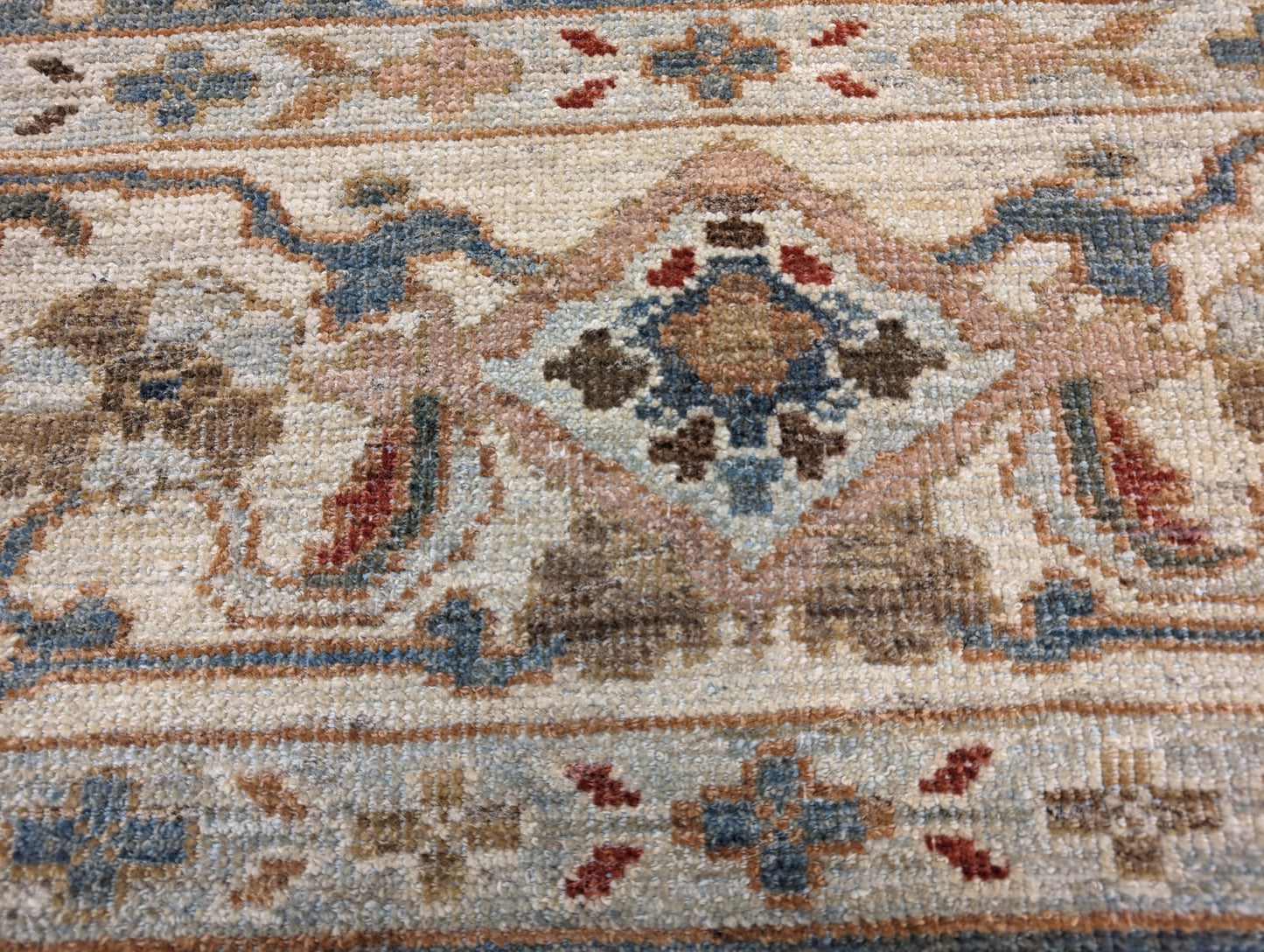 A hand-knotted wool rug with a traditional and contemporary design, featuring a luxurious color scheme of slate grey, red, gold, pink, blue, green, and beige. Low pile. 