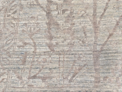A beige hand-knotted rug, featuring a soft pink silk Tree of Life design and  lower pile height. 