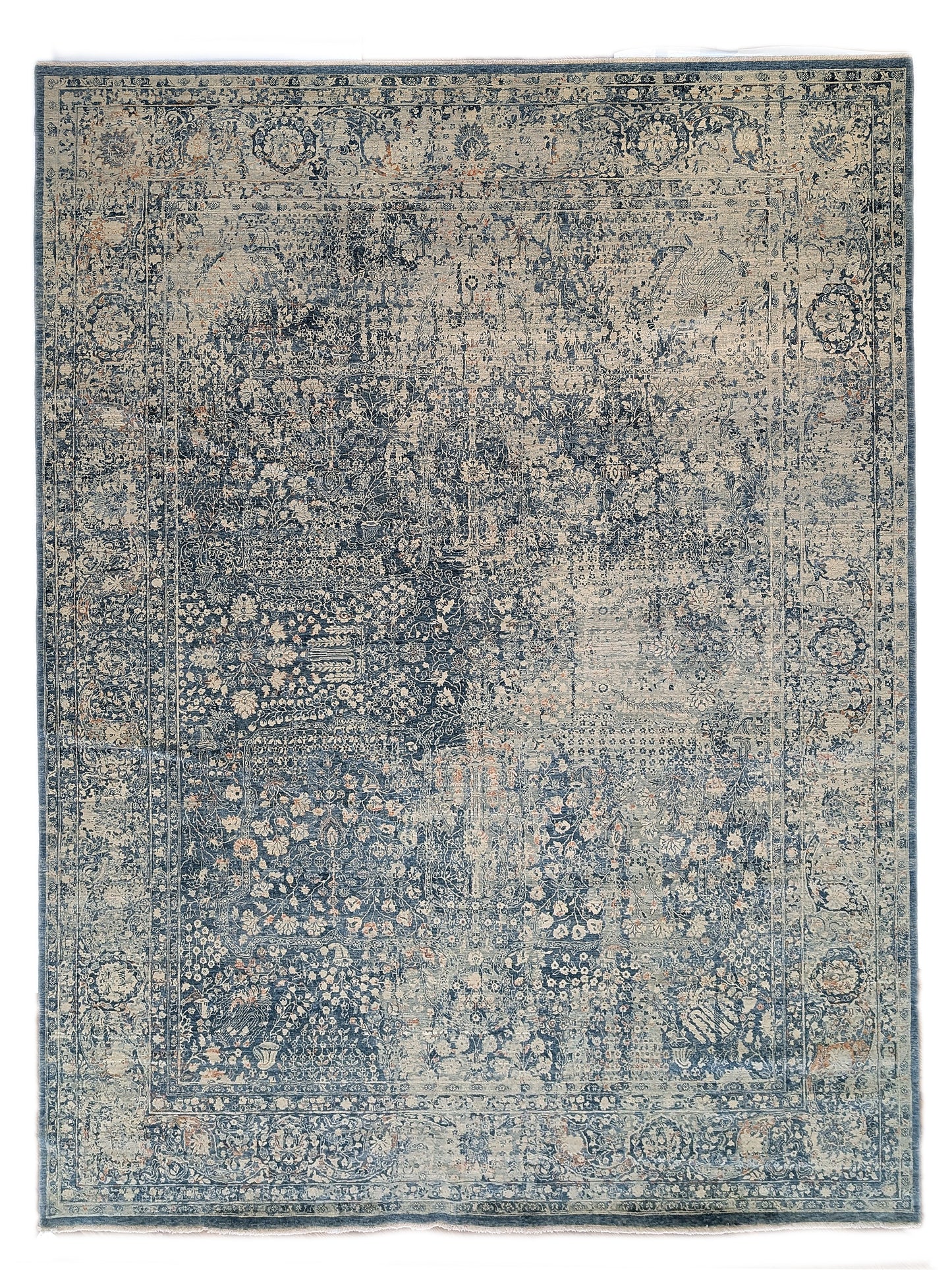 Hand- knotted decorative rug with a floral pattern in blue and beige tones 