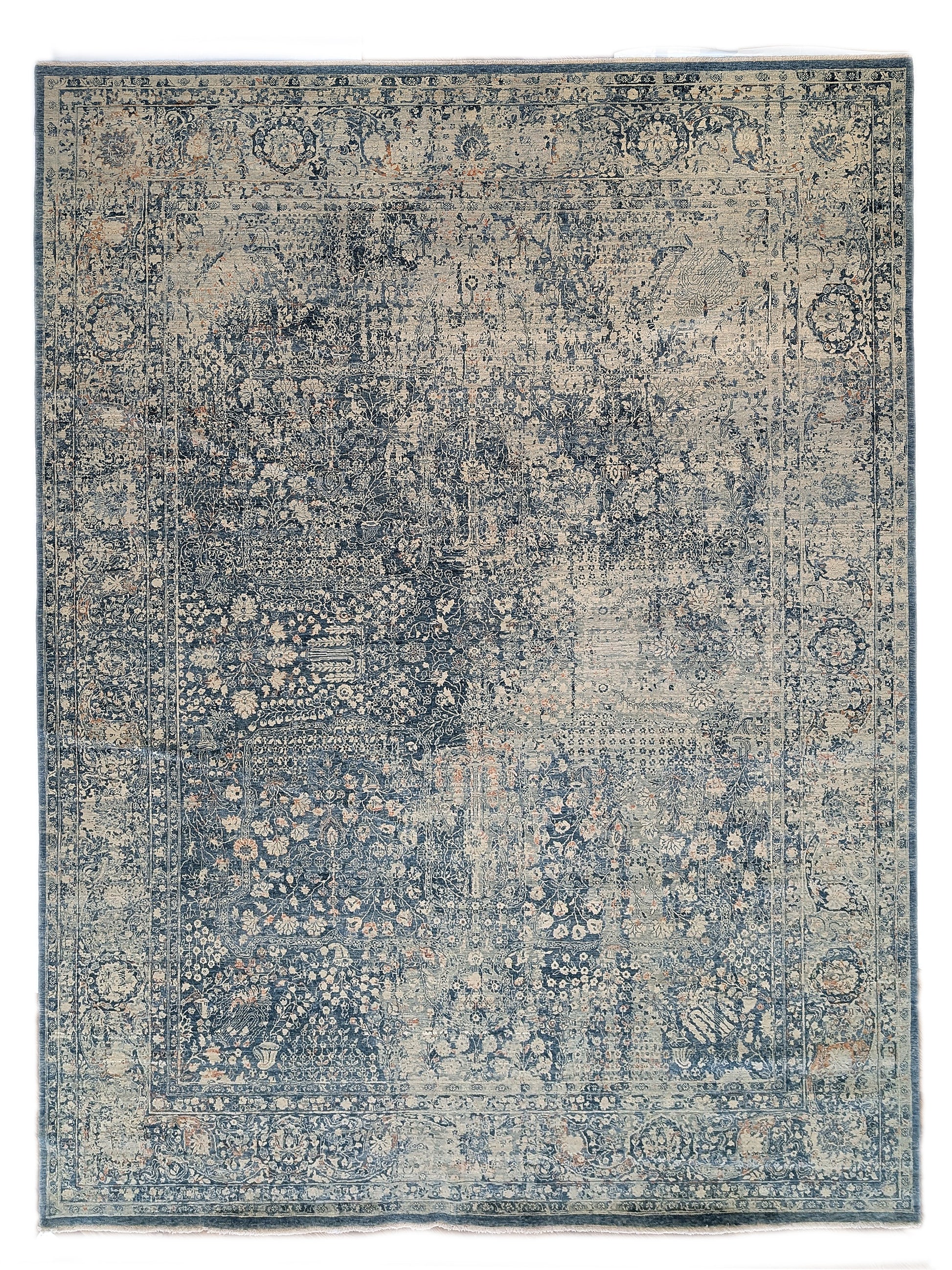 Hand- knotted decorative rug with a floral pattern in blue and beige tones 