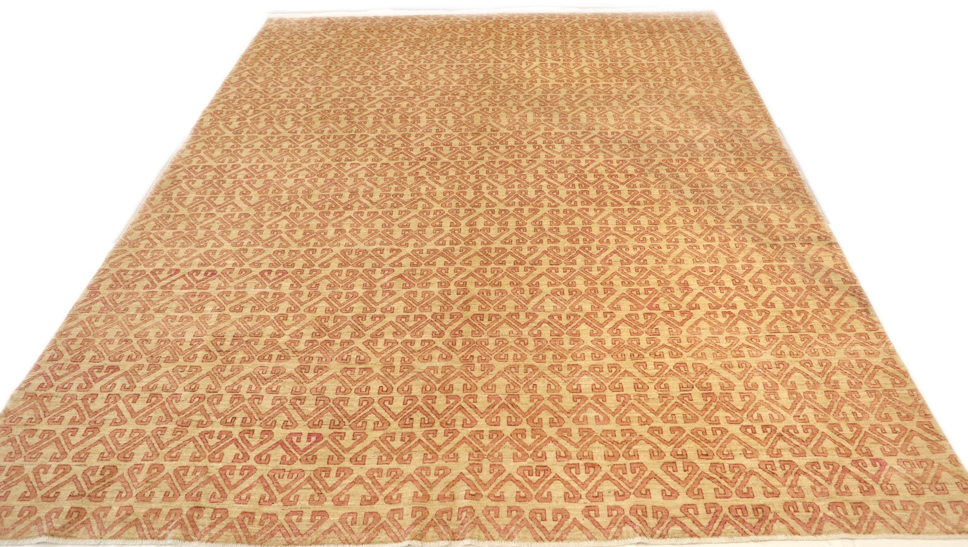 Hand-knotted sandy beige and seashell pink area rug with a subtle pattern.