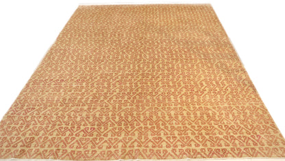 Hand-knotted sandy beige and seashell pink area rug with a subtle pattern.