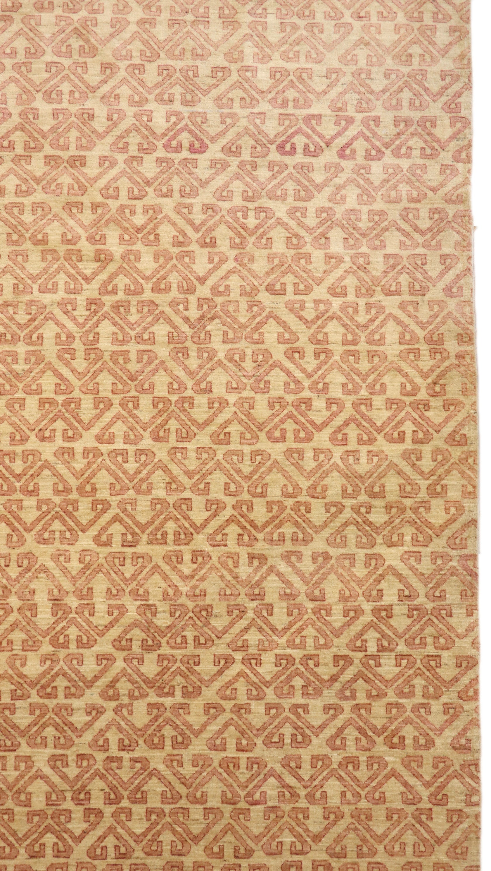 Hand-knotted sandy beige and seashell pink area rug with a subtle pattern.