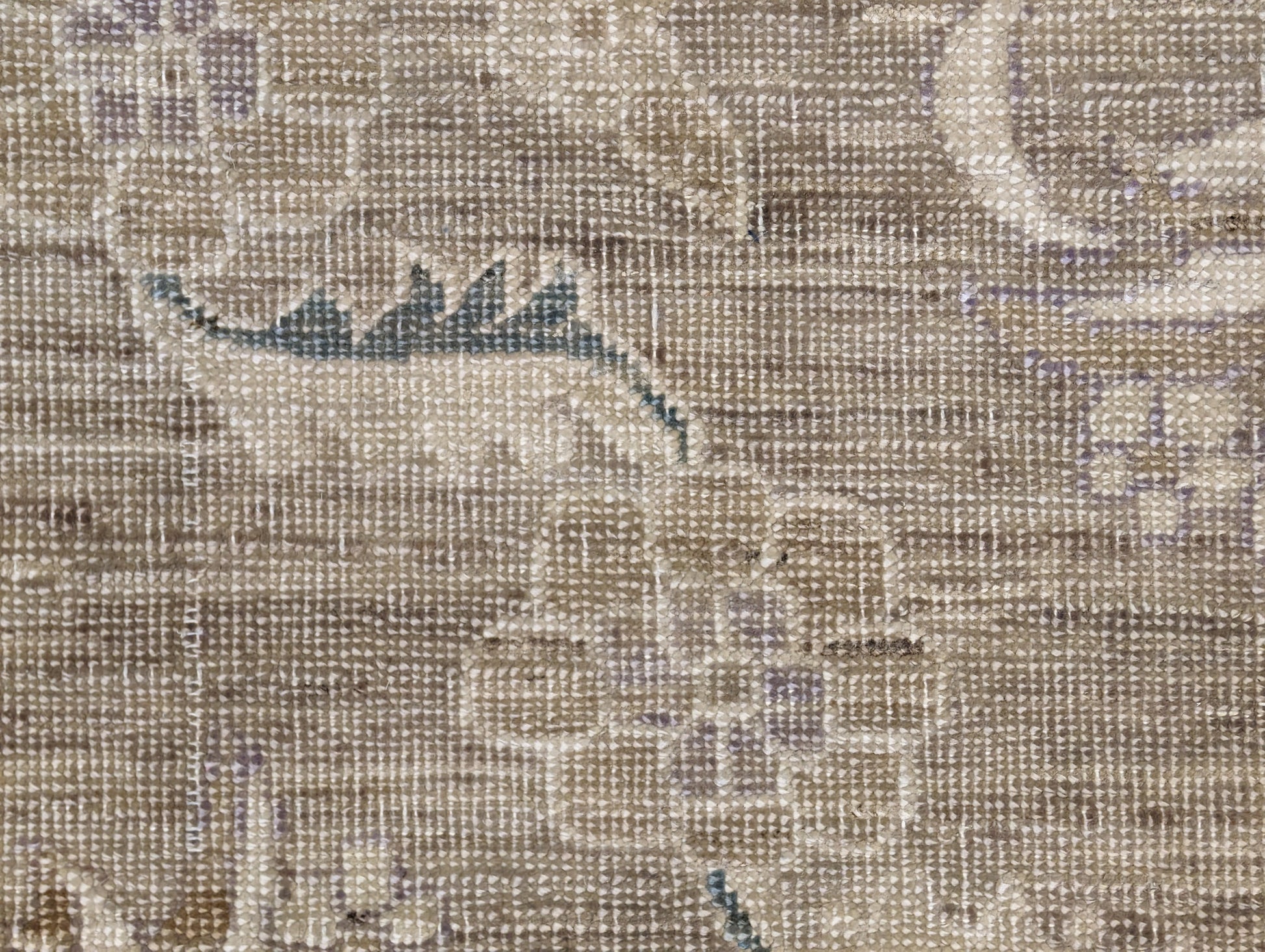 A hand-knotted wool rug with a traditional and coastal design in beige, brown, green, and other colors.